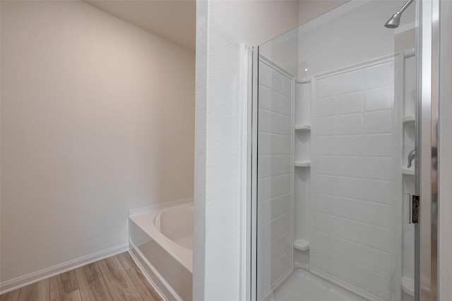 bathroom featuring hardwood / wood-style floors and independent shower and bath