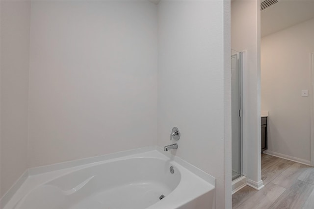 bathroom featuring vanity, hardwood / wood-style floors, and independent shower and bath