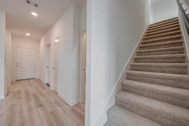 staircase featuring hardwood / wood-style flooring