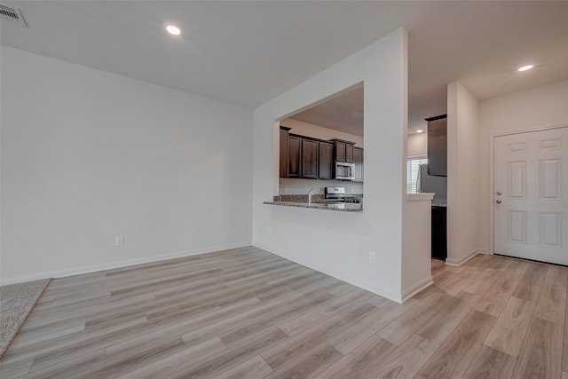 unfurnished living room with light hardwood / wood-style flooring