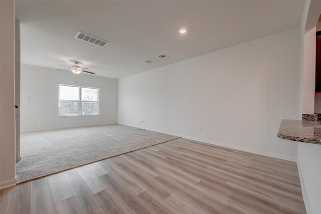 spare room with ceiling fan and light hardwood / wood-style floors