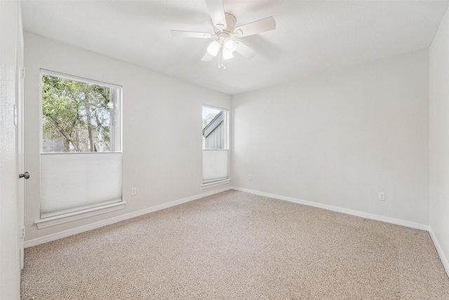 spare room with ceiling fan and carpet