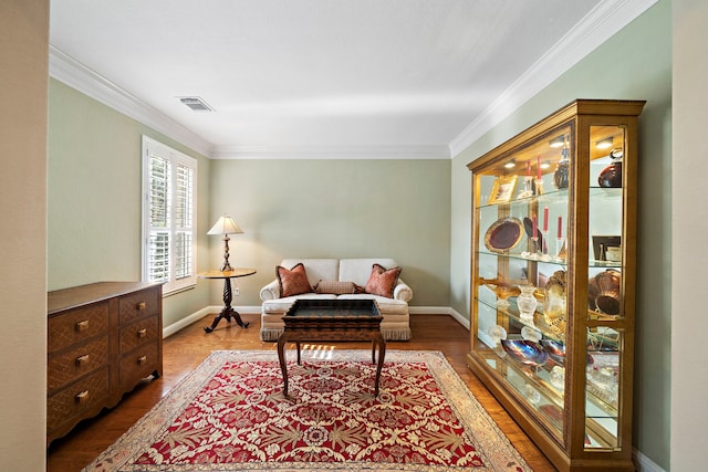 living area featuring ornamental molding and hardwood / wood-style floors