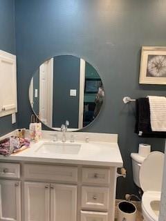 bathroom featuring vanity and toilet