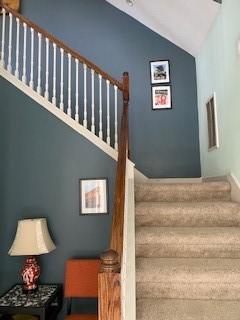 staircase featuring vaulted ceiling