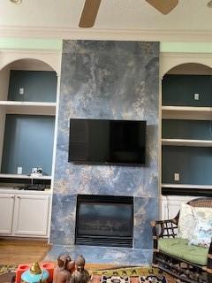 1515 Hyde Park Blvd Unit 1, Houston, TX 77006 - detailed view of a large fireplace, built in shelves, crown molding, and wood finished floors