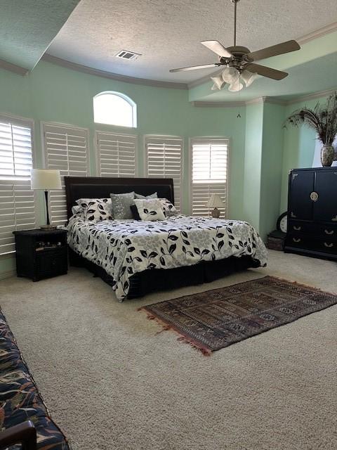 carpeted bedroom featuring crown molding and multiple windows