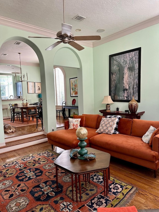 1515 Hyde Park Blvd Unit 1, Houston, TX 77006 - living area with arched walkways, crown molding, wood finished floors, a textured ceiling, and a ceiling fan