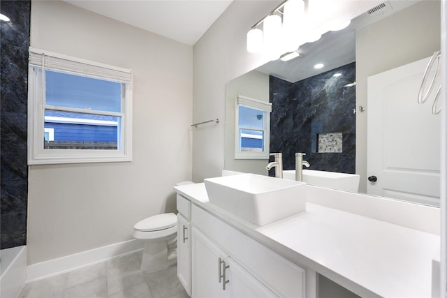 bathroom with tile patterned flooring, vanity, a tile shower, and toilet