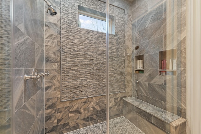 bathroom with tiled shower