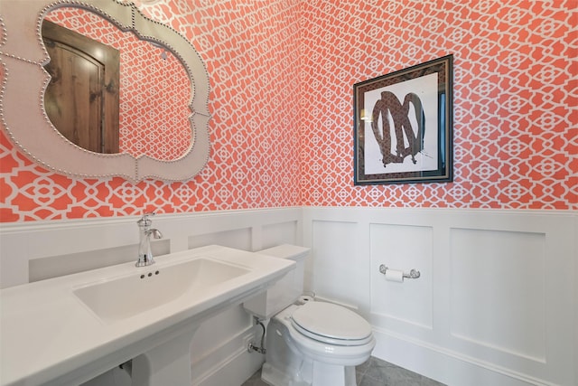 bathroom with sink, tile patterned floors, and toilet