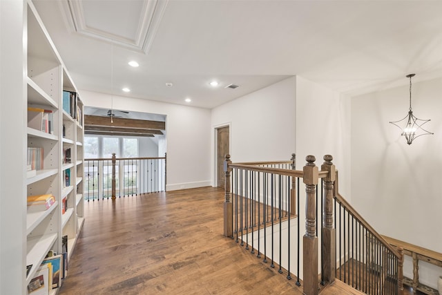 hallway with hardwood / wood-style flooring and an inviting chandelier