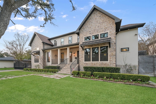 craftsman-style home featuring a porch and a front lawn