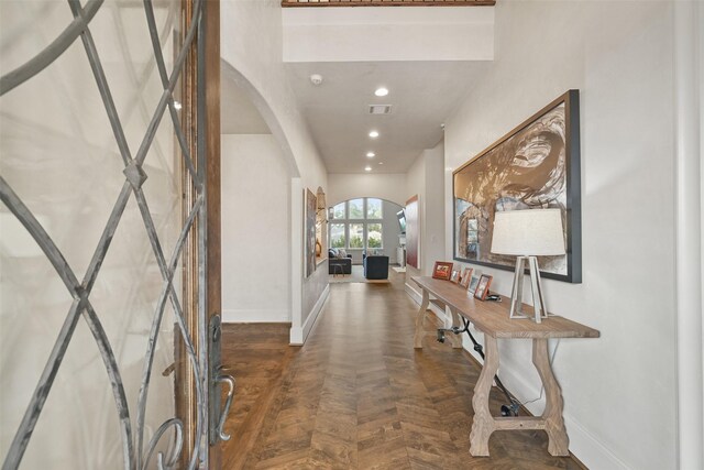 entrance foyer featuring dark parquet flooring