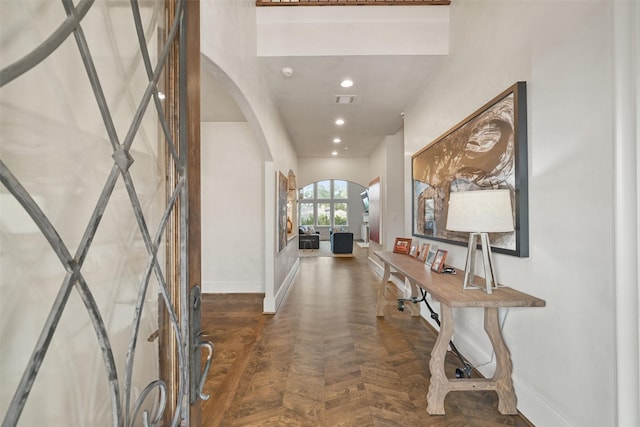 foyer featuring dark parquet flooring