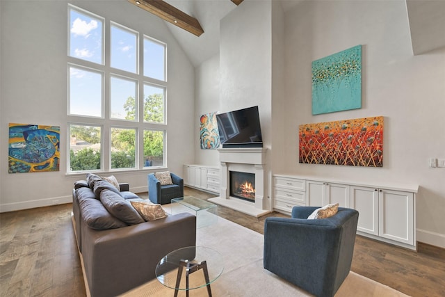 living room with beam ceiling, high vaulted ceiling, and hardwood / wood-style floors