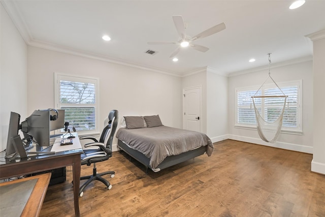 bedroom with multiple windows, wood-type flooring, and ornamental molding