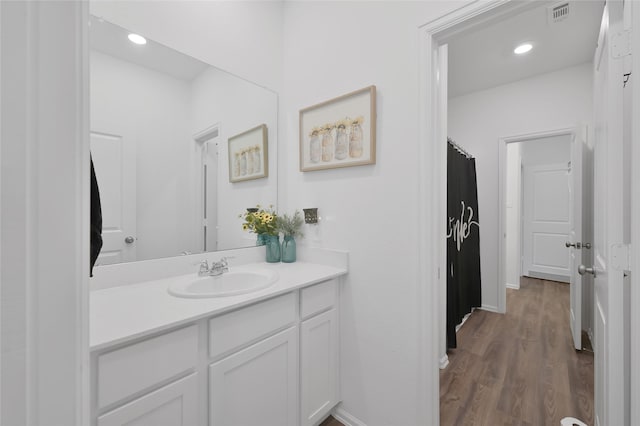 bathroom with hardwood / wood-style flooring and vanity