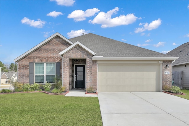 view of front of house with a garage and a front yard