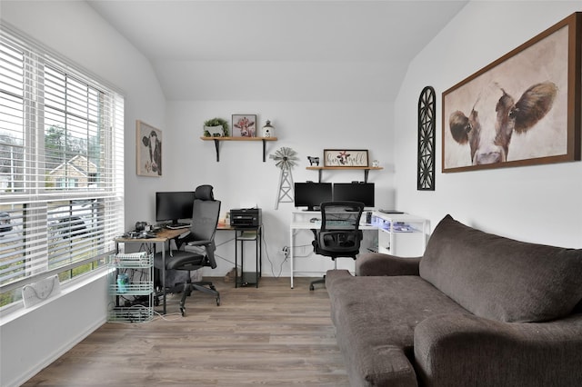 office area with lofted ceiling, plenty of natural light, and light hardwood / wood-style floors