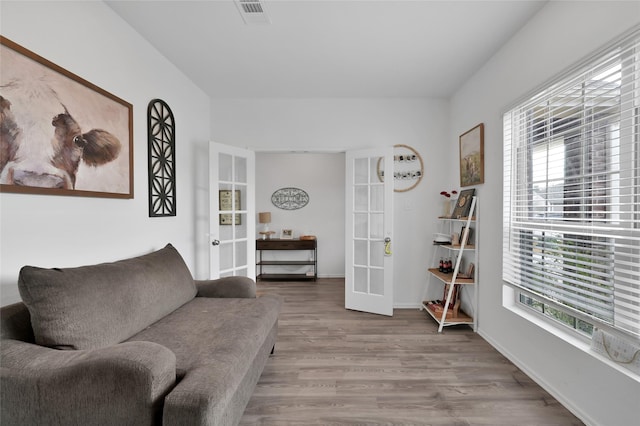 sitting room featuring french doors and light wood-type flooring