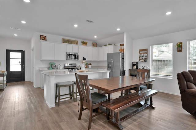 dining space featuring plenty of natural light and light wood-type flooring