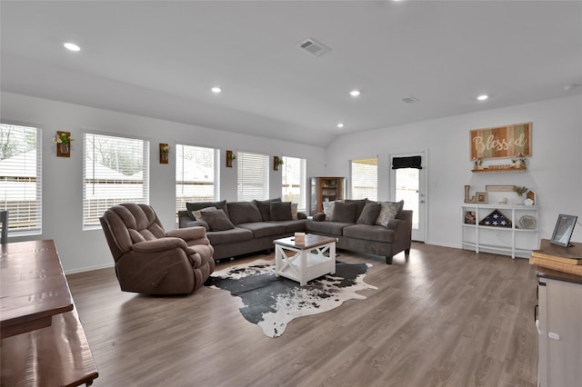 living room featuring hardwood / wood-style flooring and lofted ceiling