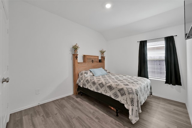 bedroom featuring lofted ceiling and hardwood / wood-style floors