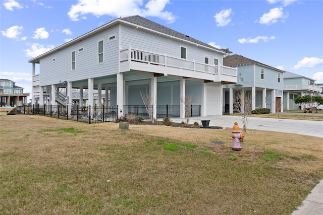 back of property featuring a carport, driveway, and a yard