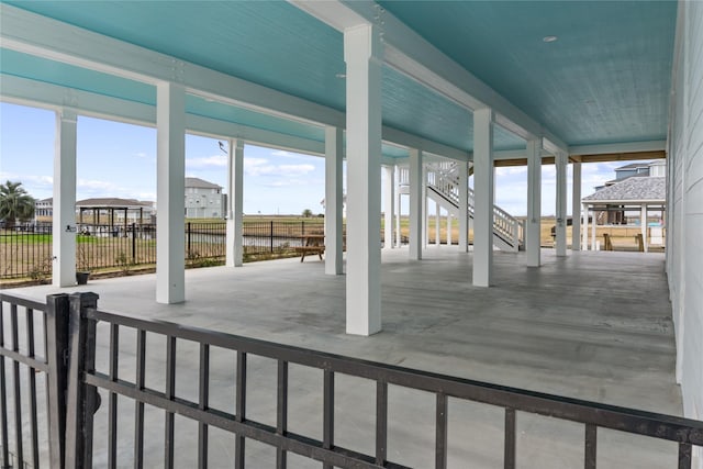 view of patio with stairs and fence