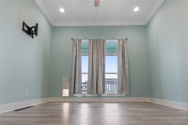 unfurnished room featuring hardwood / wood-style floors, crown molding, and ceiling fan