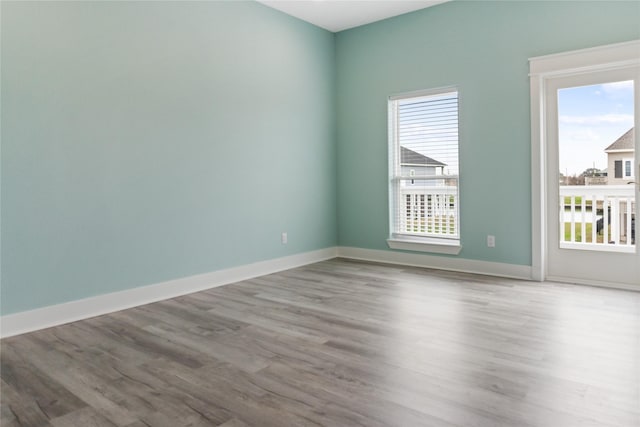 spare room with wood finished floors and baseboards