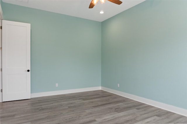 empty room with recessed lighting, a ceiling fan, baseboards, and wood finished floors