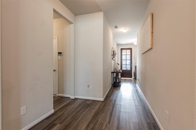 hallway with dark hardwood / wood-style floors