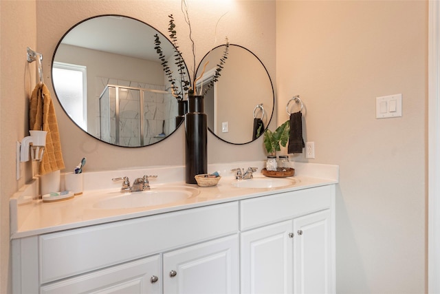 bathroom featuring vanity and a shower with shower door