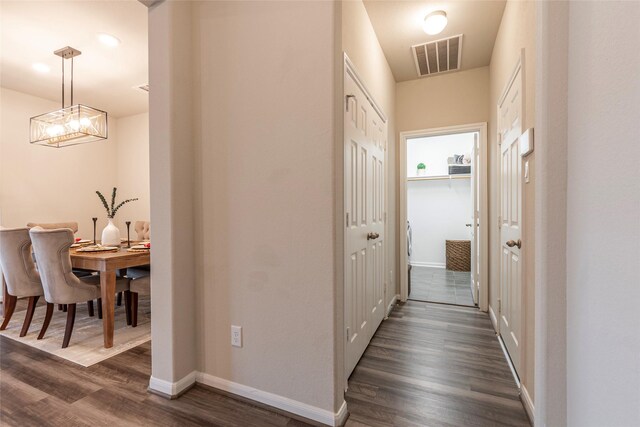 2230 Sand Lily Dr, Texas City, TX 77568 - corridor with baseboards, visible vents, dark wood finished floors, and an inviting chandelier
