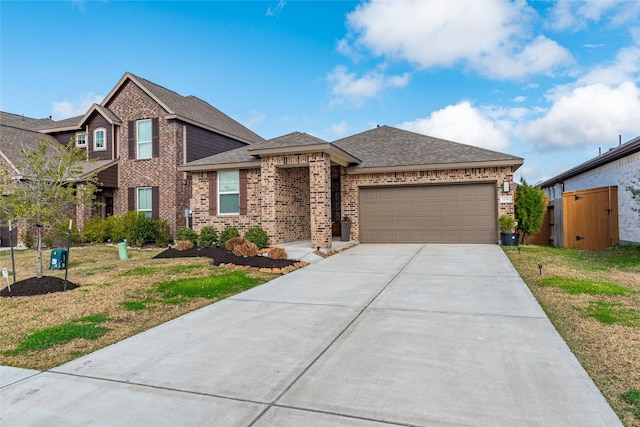 view of front of house featuring a garage and a front lawn