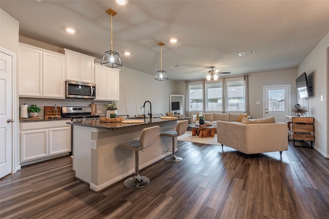 2230 Sand Lily Dr, Texas City, TX 77568 - kitchen featuring appliances with stainless steel finishes, visible vents, dark wood finished floors, and open floor plan