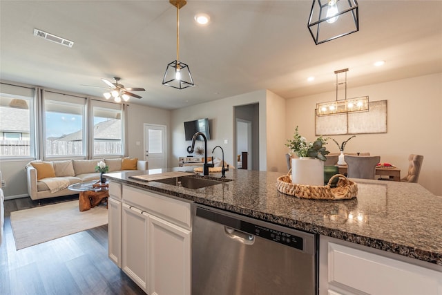 kitchen featuring sink, white cabinetry, dark stone countertops, dishwasher, and pendant lighting