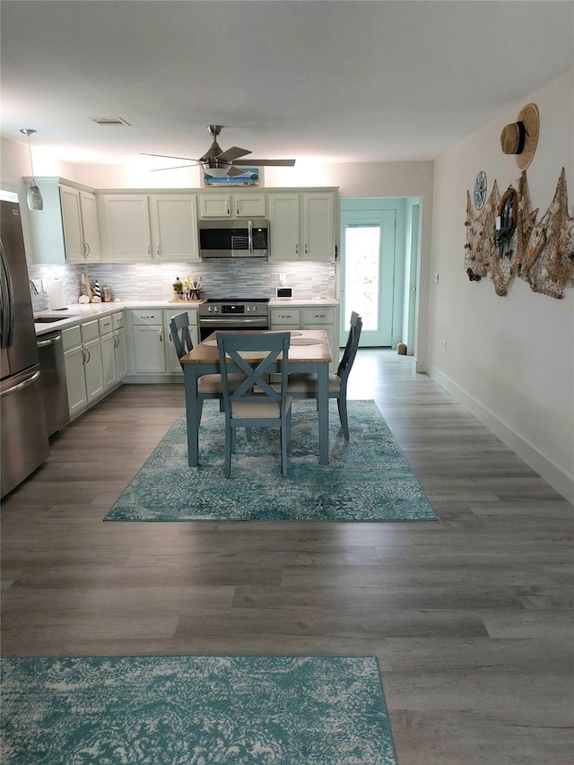 dining room featuring hardwood / wood-style floors and ceiling fan