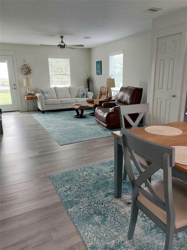 living room featuring ceiling fan and light wood-type flooring