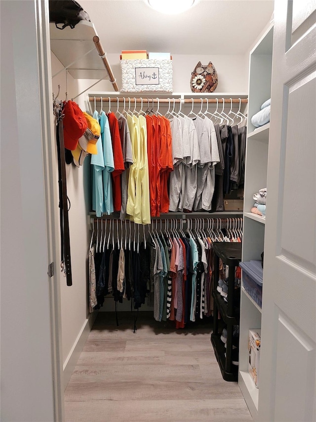 spacious closet featuring light wood-type flooring