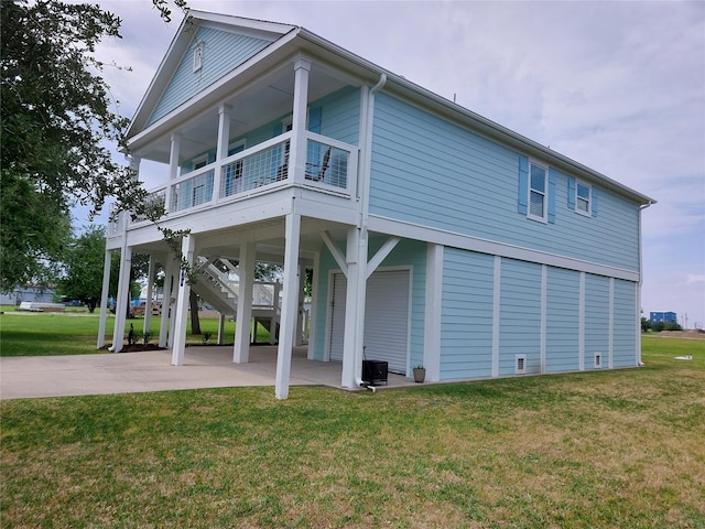 rear view of property featuring a patio area and a lawn