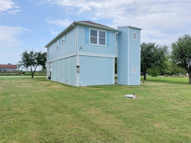 view of side of home featuring a lawn