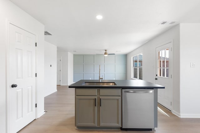 kitchen with sink, stainless steel dishwasher, an island with sink, and light wood-type flooring