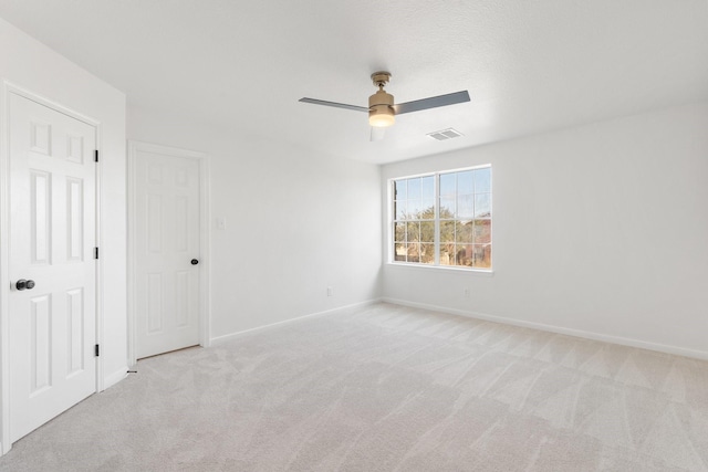 unfurnished bedroom with ceiling fan and light carpet