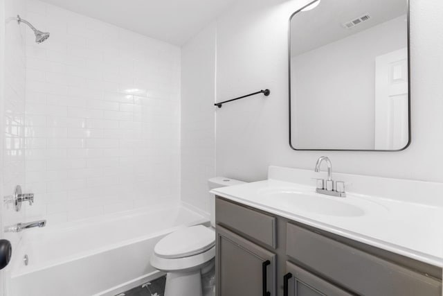 full bathroom featuring tiled shower / bath, vanity, and toilet