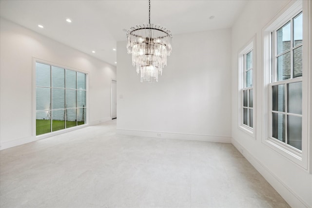 unfurnished room featuring baseboards, a notable chandelier, and recessed lighting