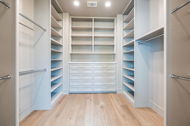 spacious closet featuring light wood-style flooring and visible vents