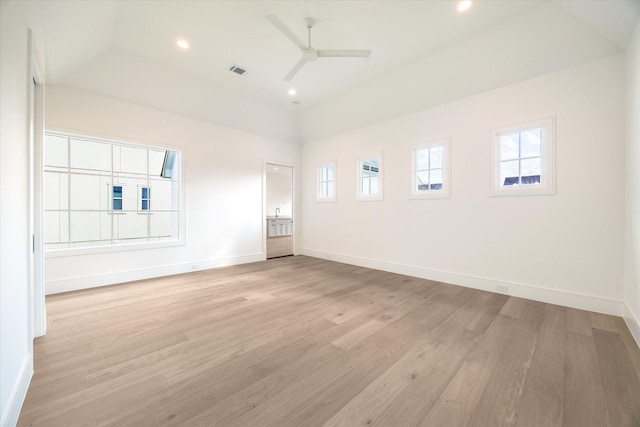 spare room featuring light wood-type flooring, visible vents, ceiling fan, and baseboards